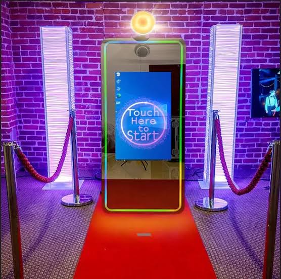 Magic Mirror photo booth glowing under twinkle lights